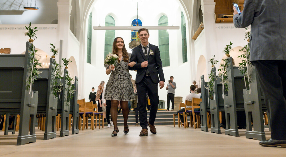 Brudepar går ned gennem kirkeskibet efter deres vielse
